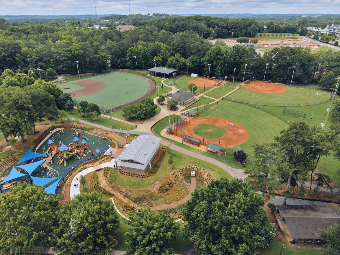 Arial view of a construction site, consisting mostly of a dirt lot and construction vehicles, in Alpharetta.