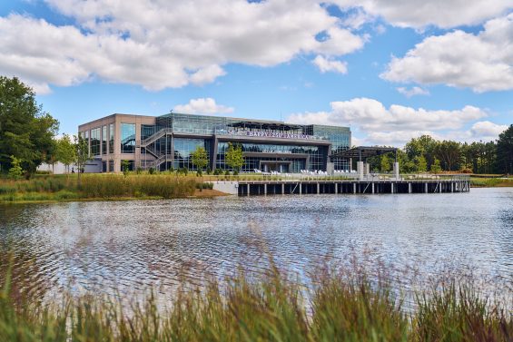 View of Johns Creek City Hall from across a manmade body of water.